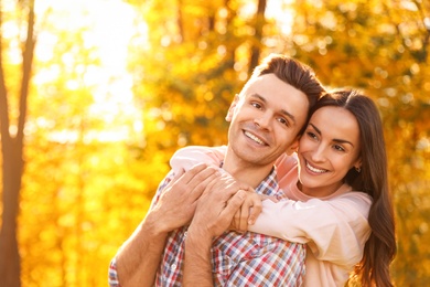 Happy couple in sunny park. Autumn walk