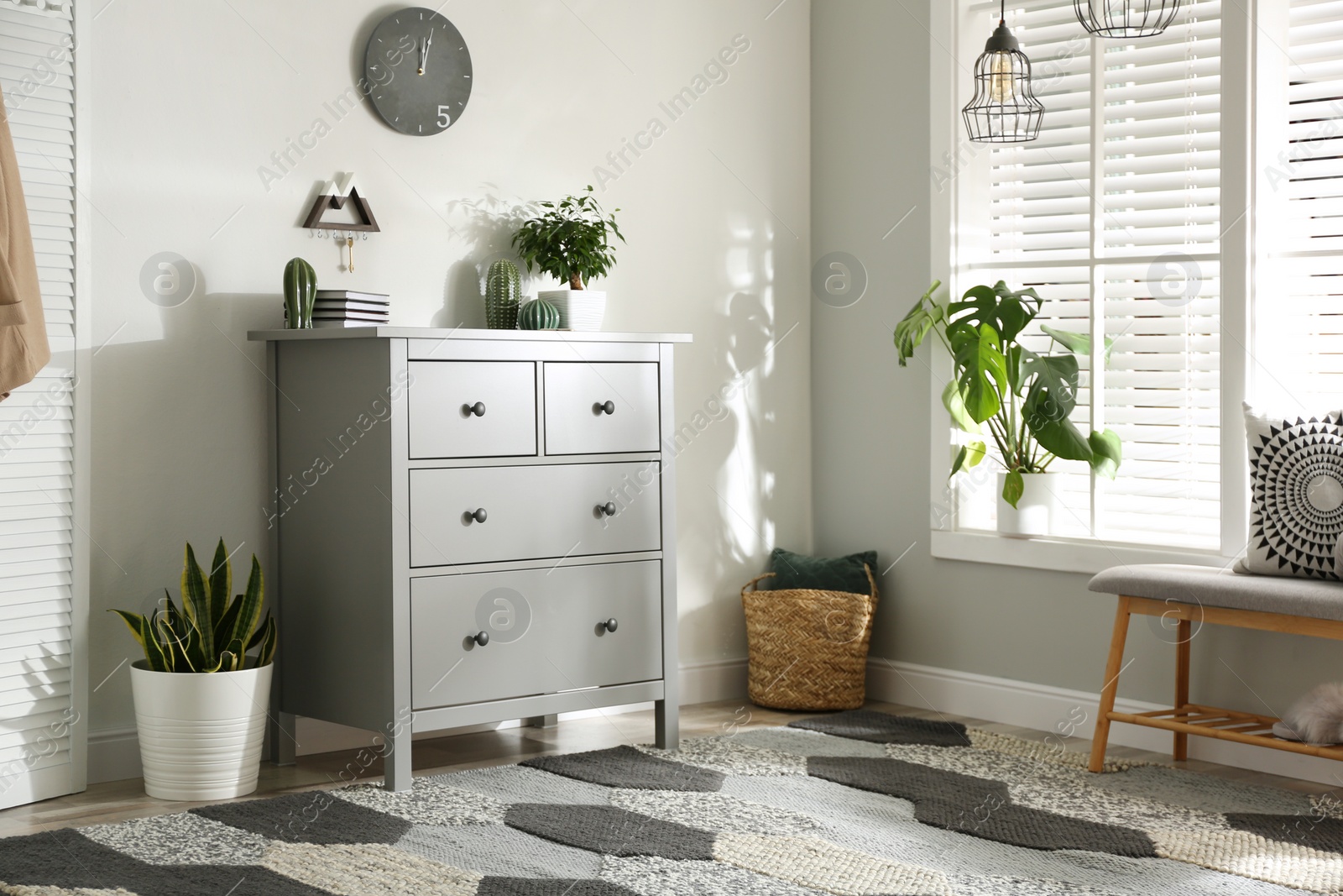 Photo of Grey chest of drawers in stylish room interior