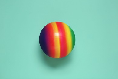 Photo of New bright kids' ball on turquoise background, top view