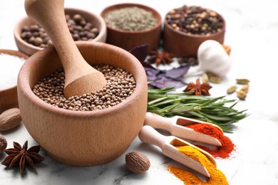 Mortar and spices on white marble table, closeup