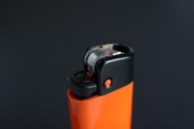 Photo of Stylish small pocket lighter on black background, closeup