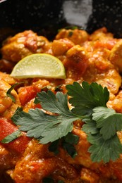 Delicious chicken curry with parsley in bowl, closeup