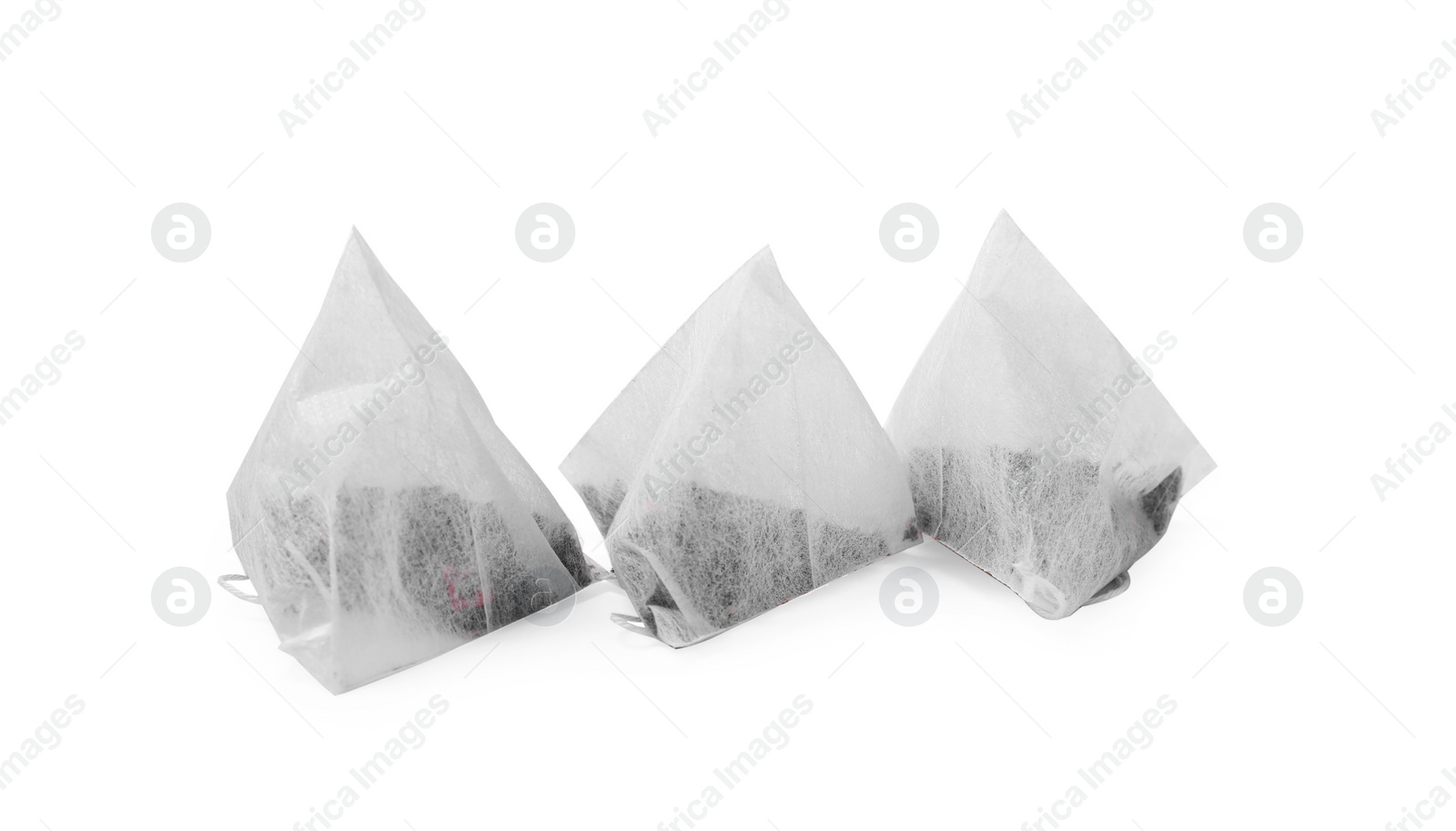 Photo of Three new tea bags on white background