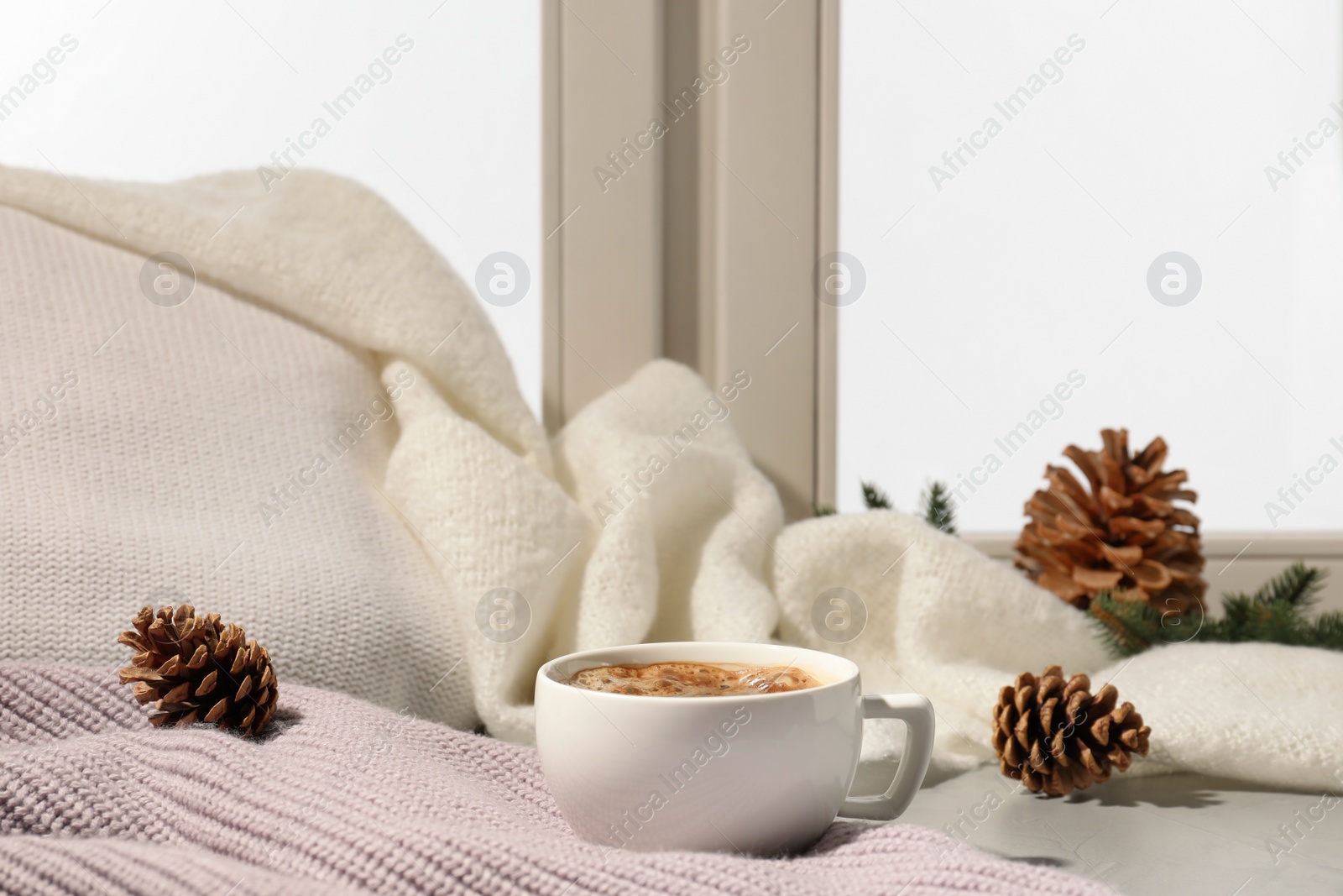 Photo of Cup of coffee on windowsill indoors, space for text. Winter drink