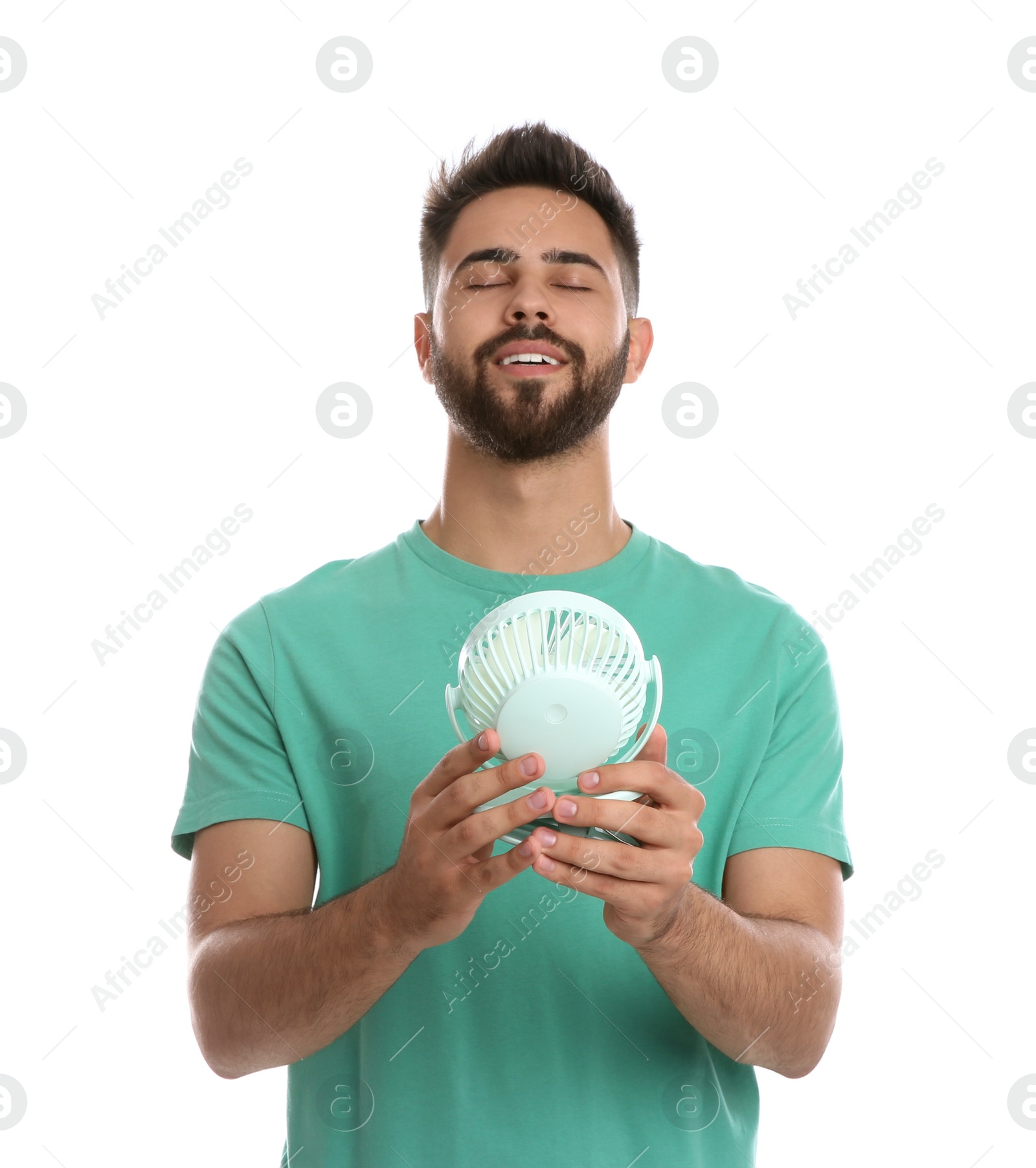 Photo of Man enjoying air flow from portable fan on white background. Summer heat