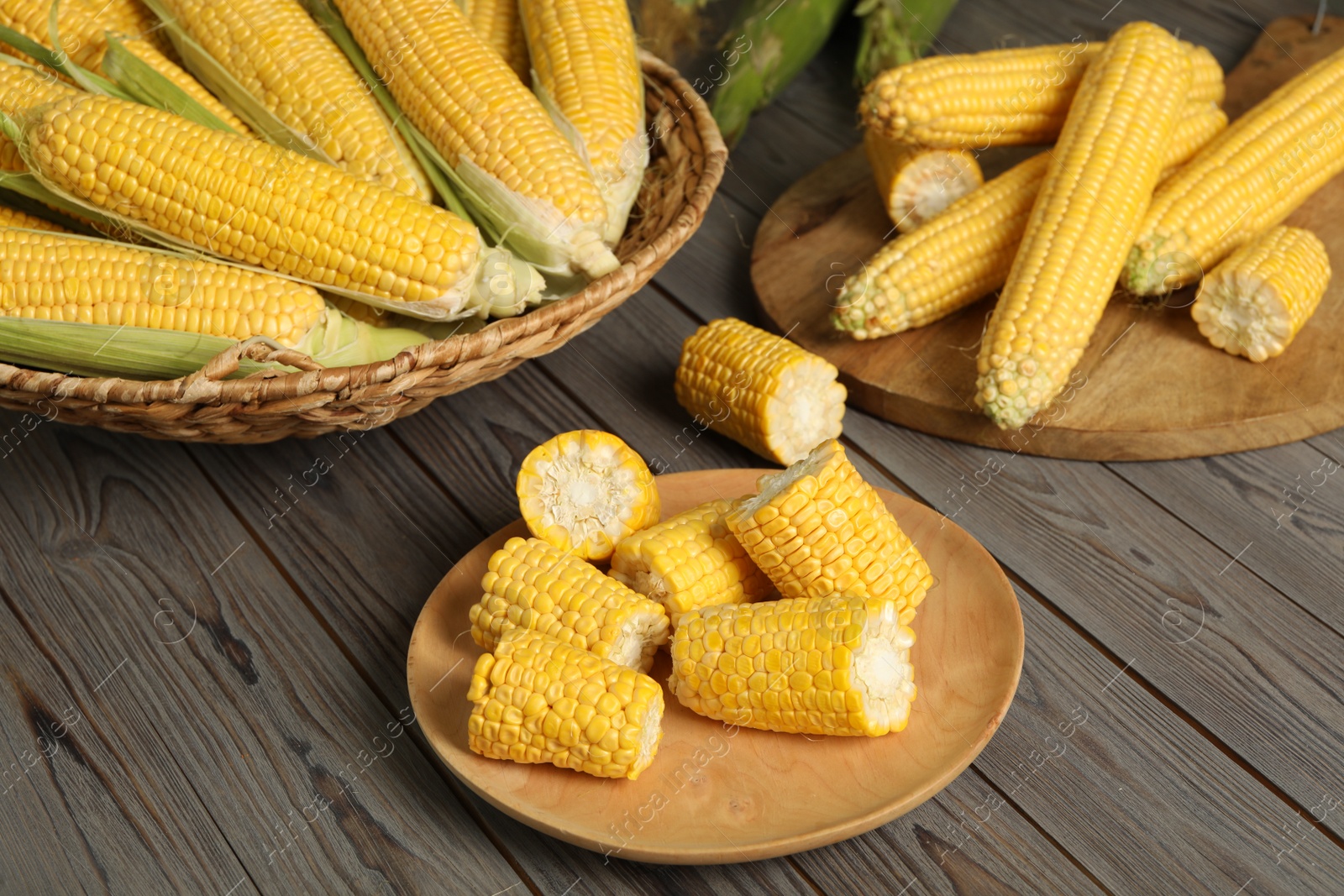 Photo of Tasty sweet corn cobs on wooden table