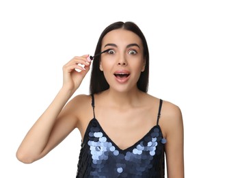 Photo of Beautiful emotional woman applying mascara on white background