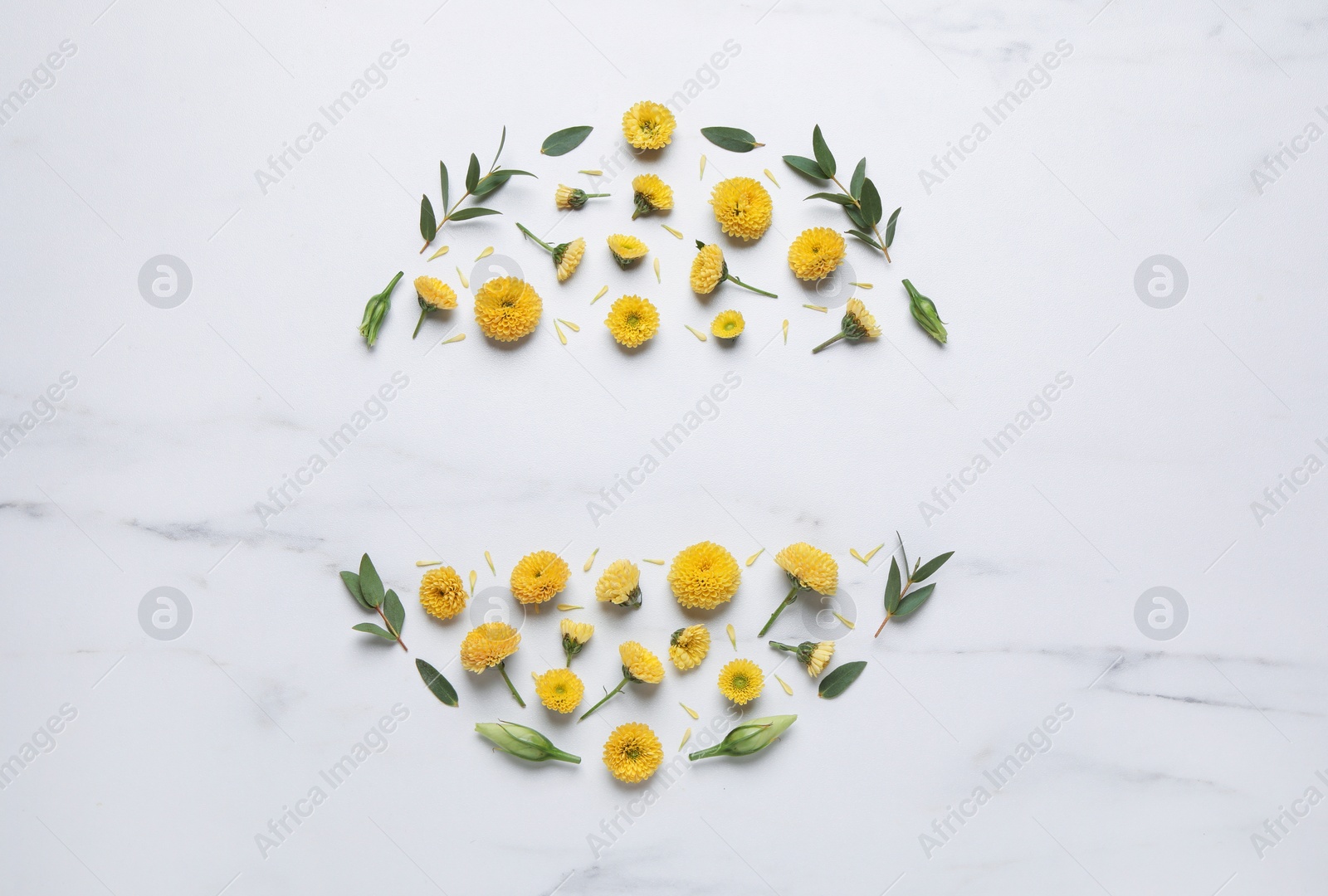 Photo of Wreath made of chrysanthemum flowers and green leaves on white marble background, flat lay. Space for text