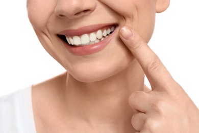 Young woman with beautiful smile on white background, closeup. Teeth whitening