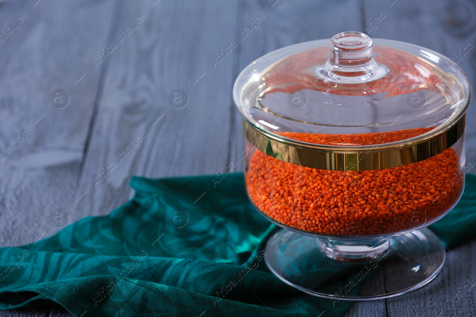 Photo of Red lentil on blue wooden table, space for text. Foodstuff for modern kitchen