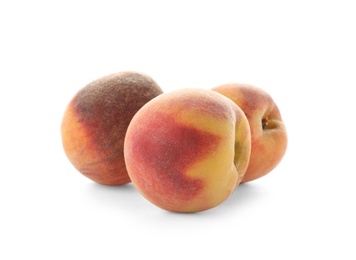 Fresh sweet peaches on white background