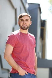 Photo of Portrait of young man in stylish outfit outdoors