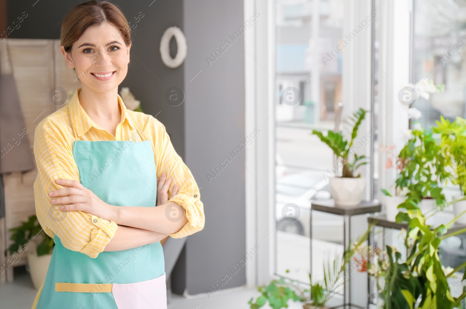 Photo of Portrait of attractive female florist at workplace