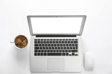 Photo of Modern laptop and cup of coffee on white background, top view