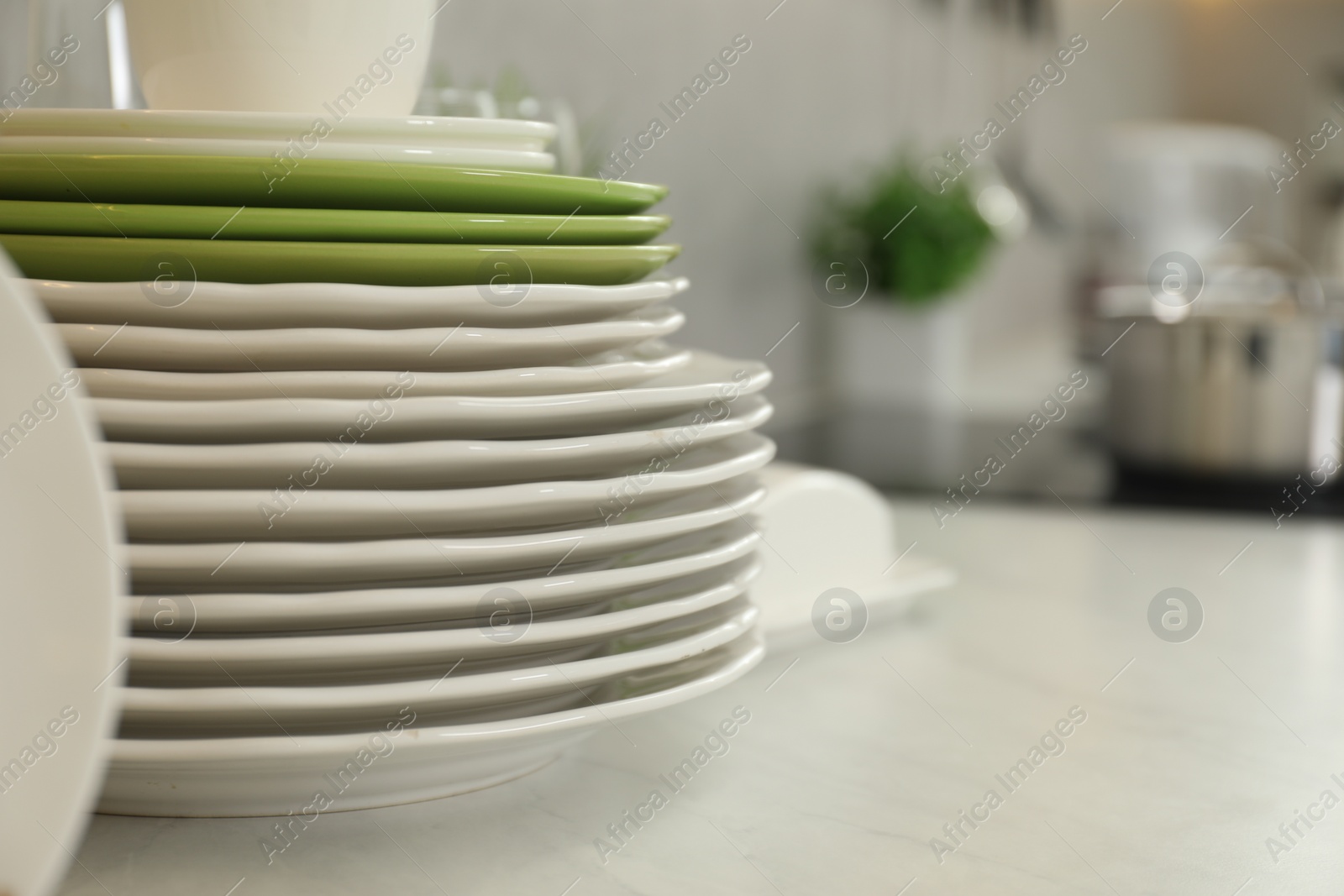 Photo of Clean plates on white marble table, space for text