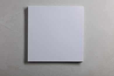 Photo of Blank paper sheets on grey textured background, top view. Mockup for design