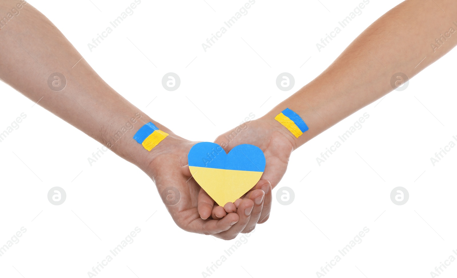 Photo of Man and woman holding paper heart in colors of Ukrainian flag on white background, closeup