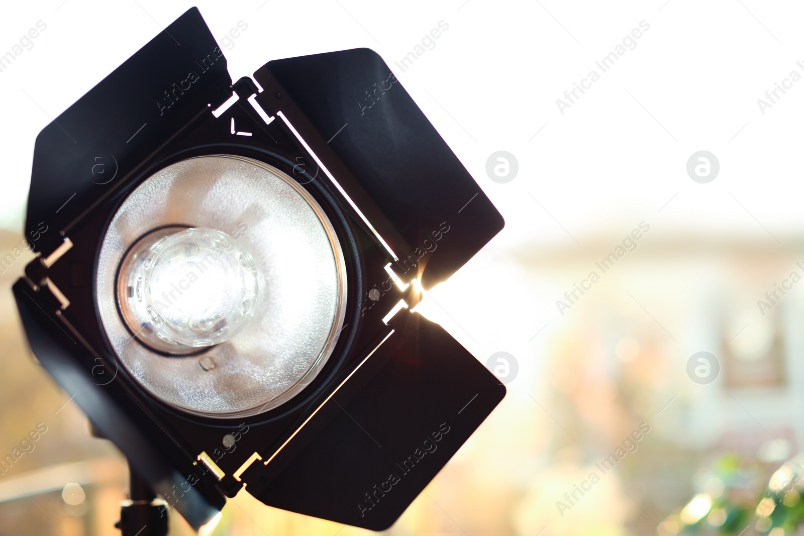 Photo of Professional photo studio lighting equipment on blurred background. Space for text