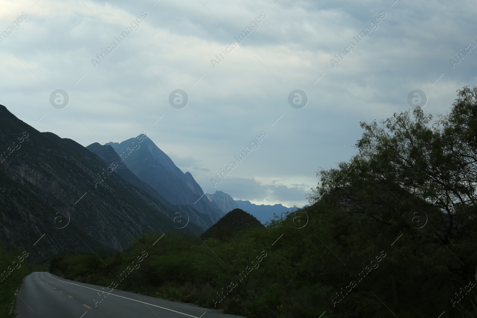 Photo of Beautiful view of empty asphalt highway near mountains outdoors. Road trip