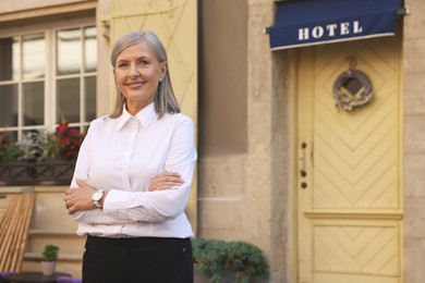 Photo of Happy business owner near her hotel outdoors, space for text