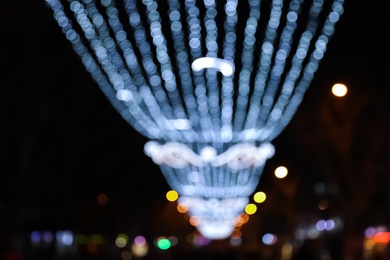 Photo of Beautiful bright Christmas decor outdoors, low angle view. Bokeh effect