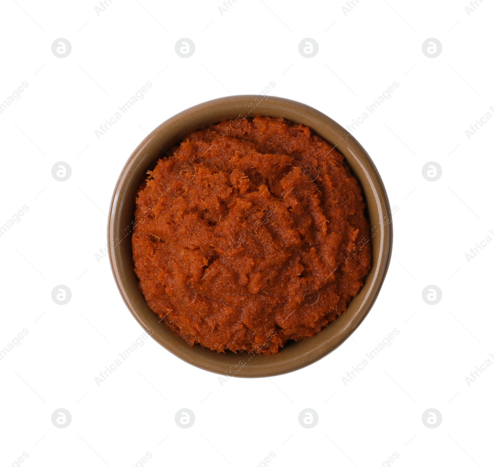 Photo of Tasty curry paste in bowl isolated on white, top view