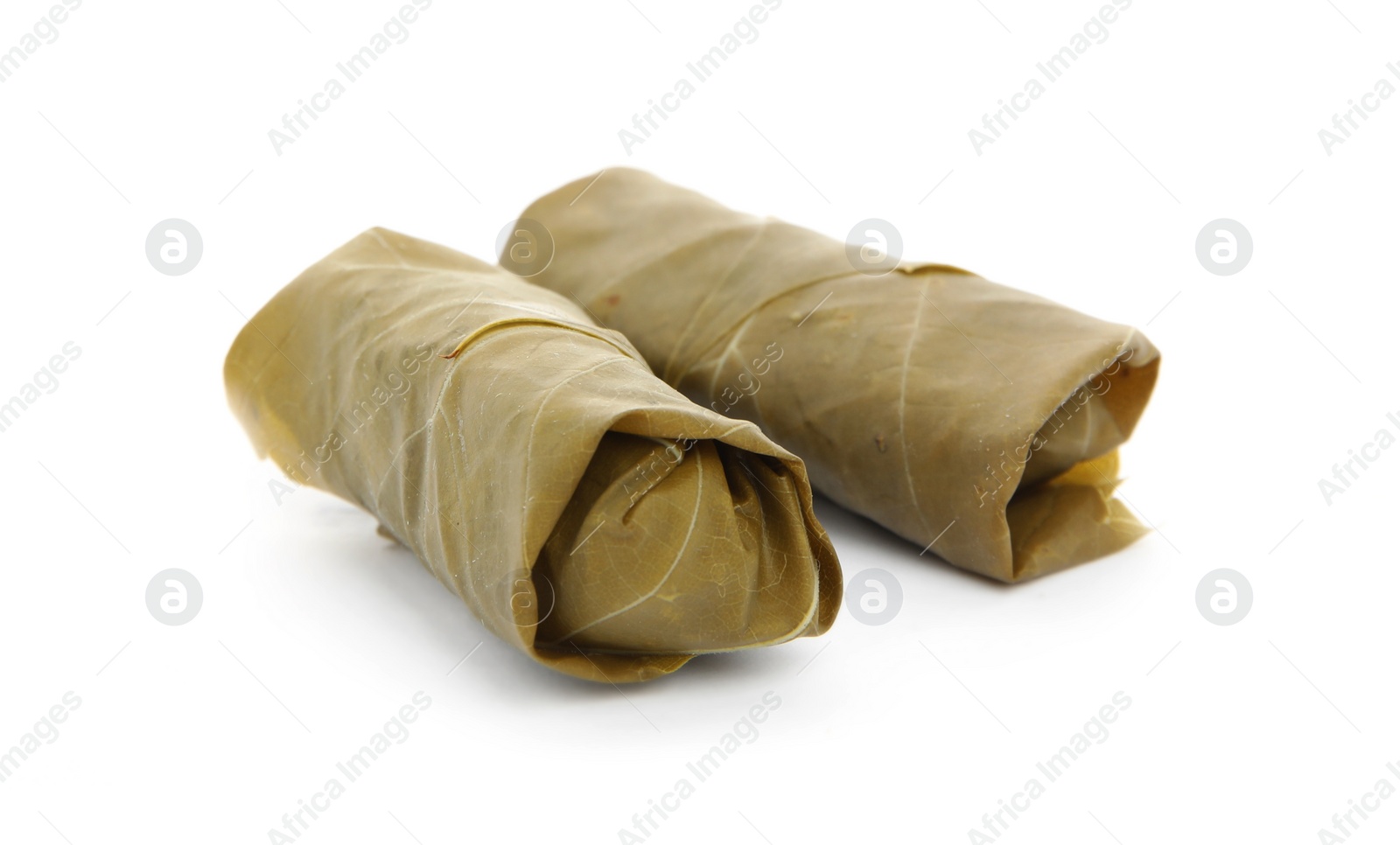 Photo of Delicious stuffed grape leaves on white background