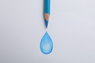 Photo of Drawing of water drop and light blue pencil on white background, top view