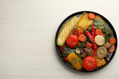 Photo of Delicious grilled vegetables on white wooden table, top view. Space for text