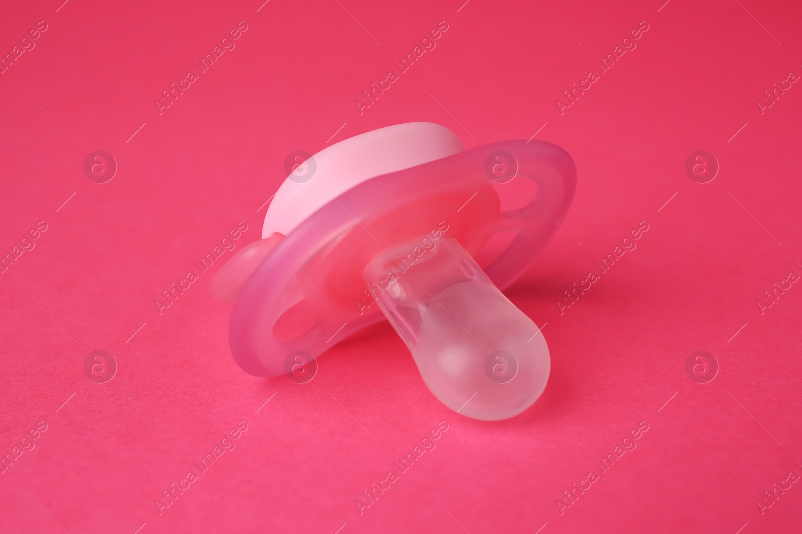 Photo of One new baby pacifier on pink background