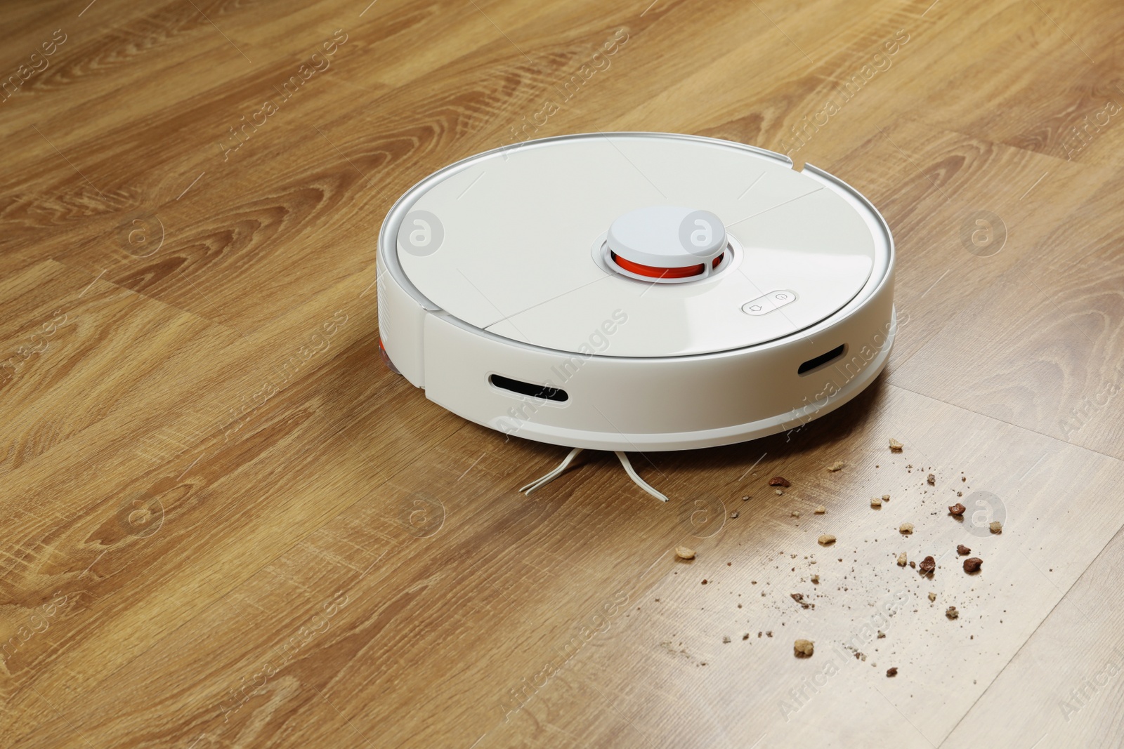 Photo of Robotic vacuum cleaner soil from wooden floor indoors