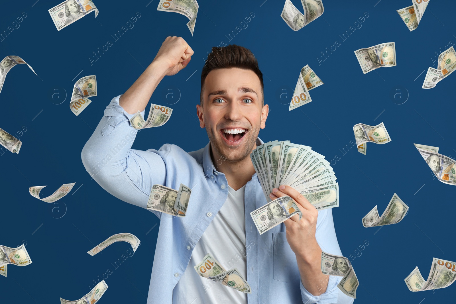 Image of Man with American dollars under money rain on blue background