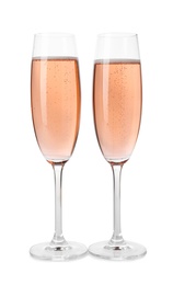 Photo of Glasses of rose champagne isolated on white