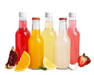 Delicious kombucha in glass bottles, fresh fruits and coconut isolated on white