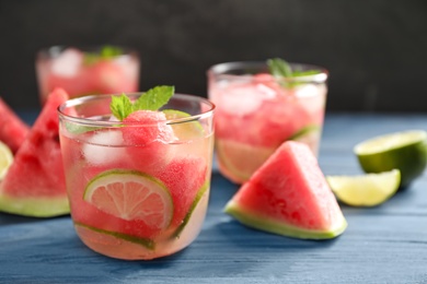 Photo of Delicious refreshing watermelon drink on blue wooden table