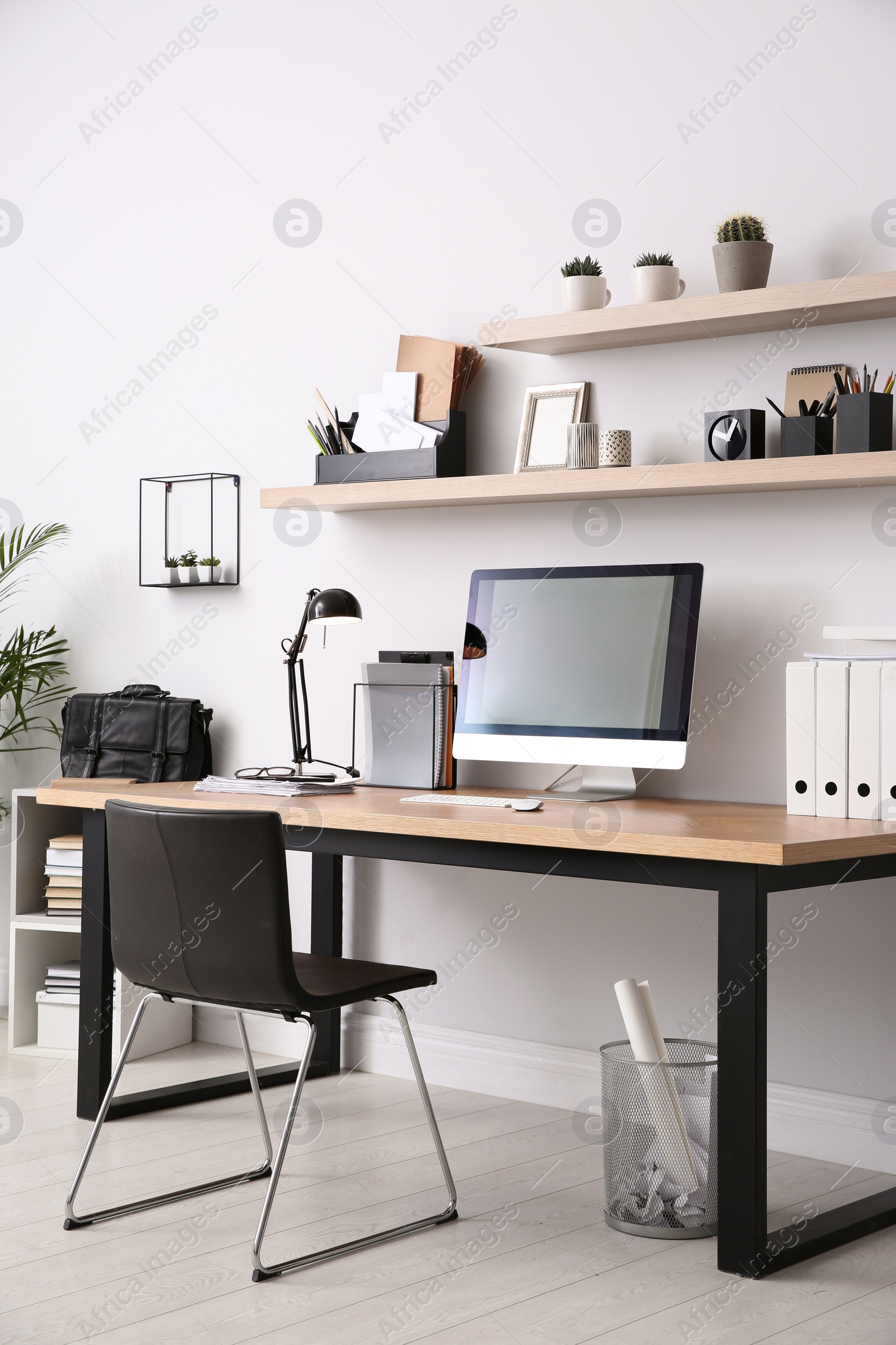 Photo of Modern computer on table in office interior. Stylish workplace