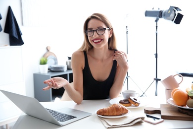 Photo of Portrait of food blogger with laptop at home