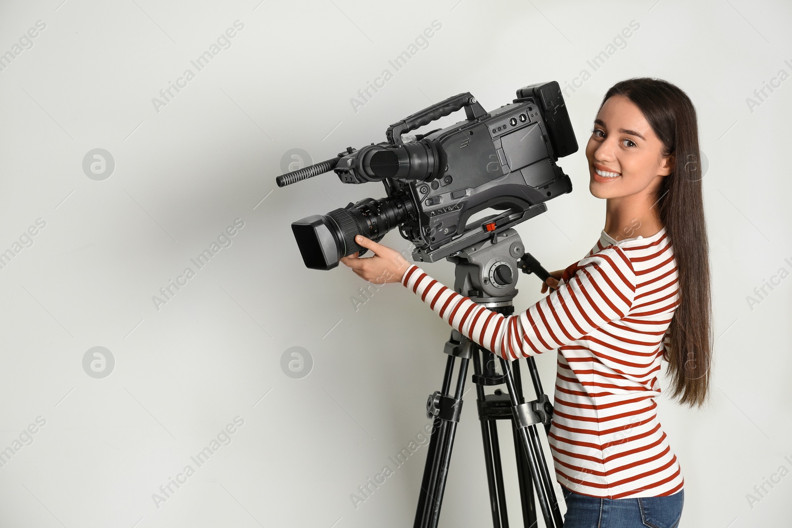 Photo of Operator with professional video camera on white background