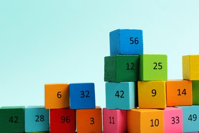 Photo of Wooden cubes with different numbers on light background