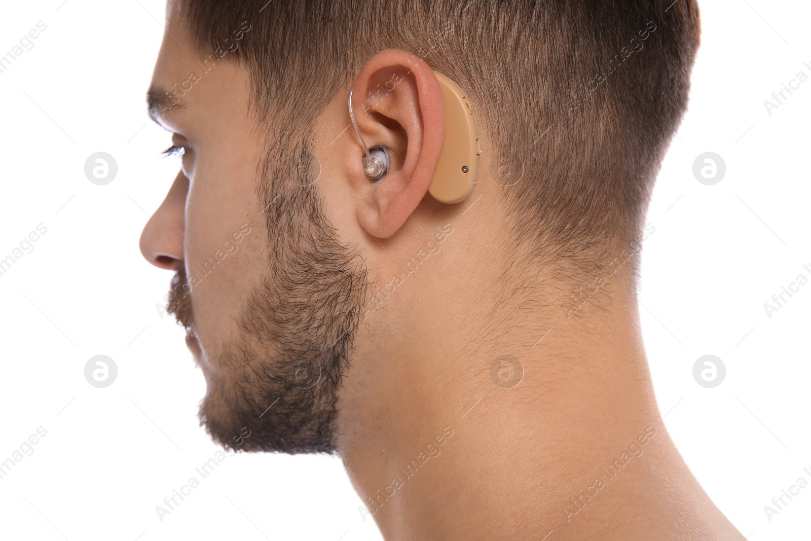 Photo of Young man with hearing aid on white background