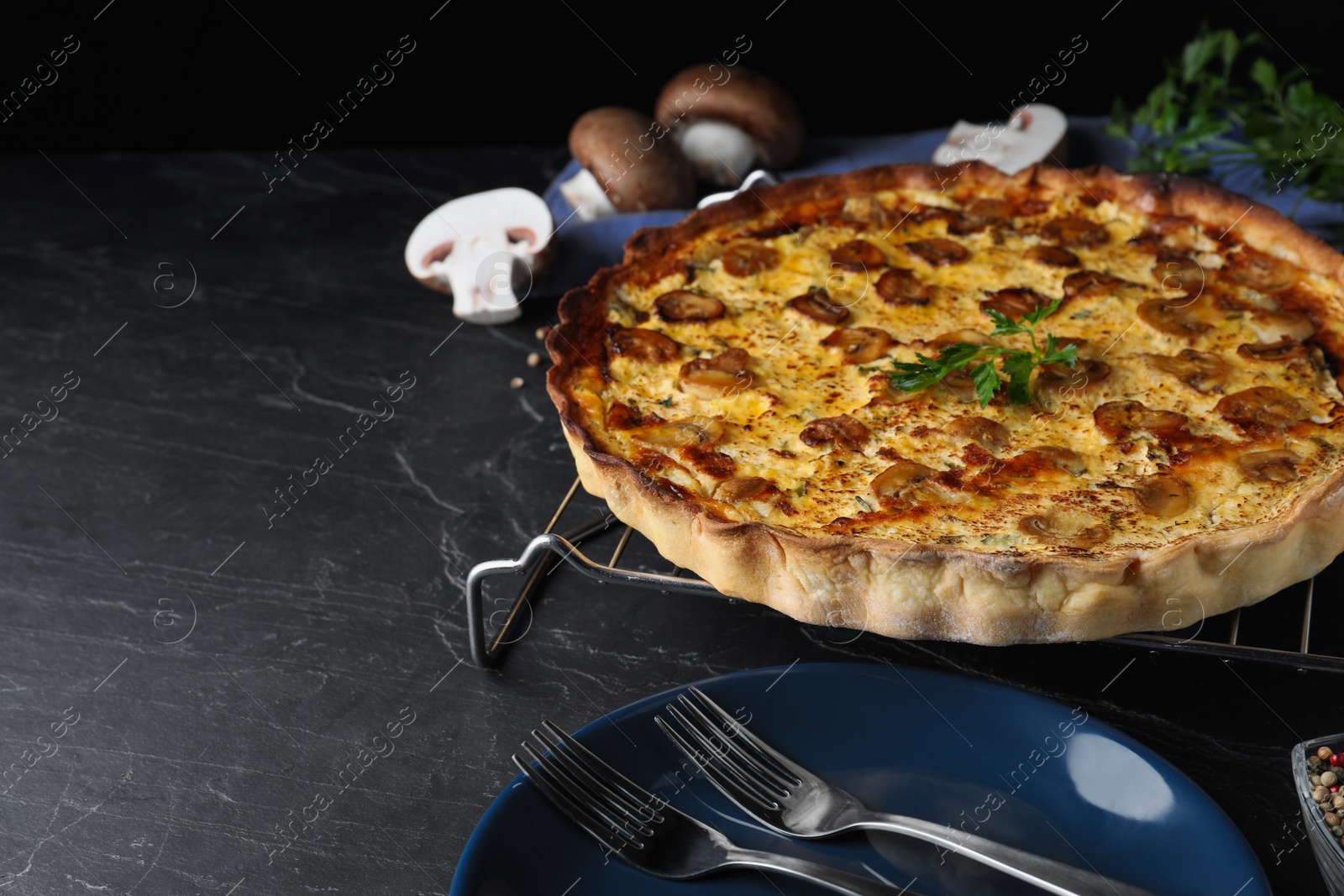 Photo of Delicious homemade mushroom pie on black table