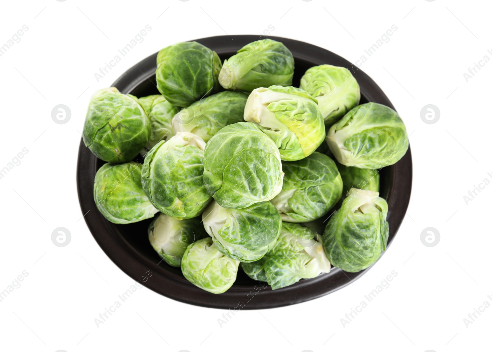 Photo of Fresh Brussels sprouts in bowl isolated on white, top view