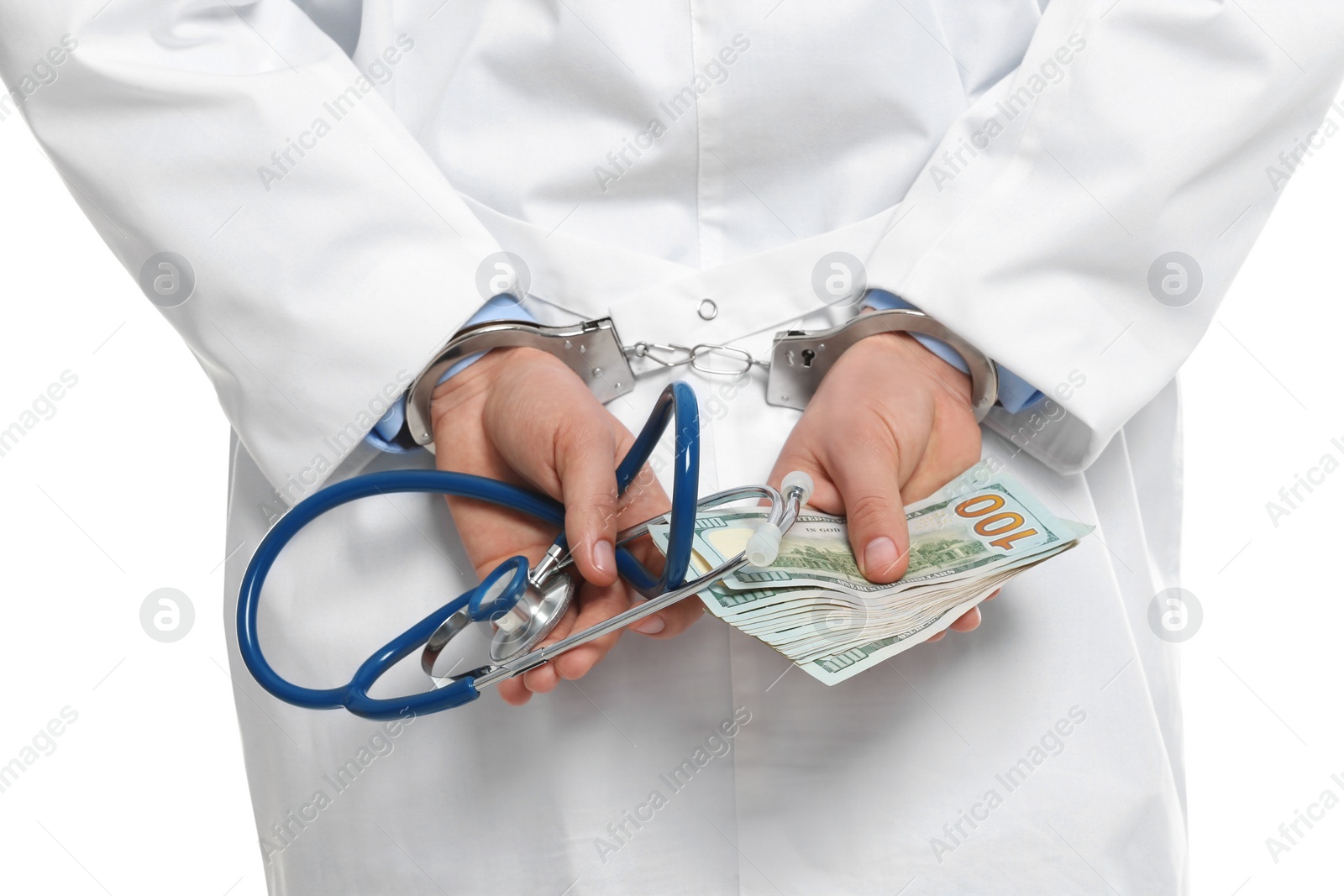 Photo of Doctor in handcuffs with bribe and stethoscope on white background, closeup. Corrupted medicine