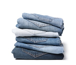 Image of Stack of different folded jeans isolated on white