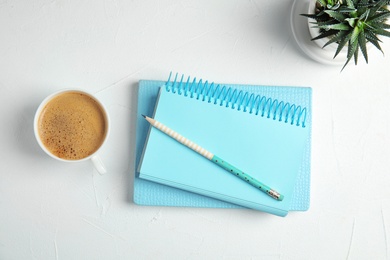 Photo of Flat lay composition with notebooks and coffee on white background