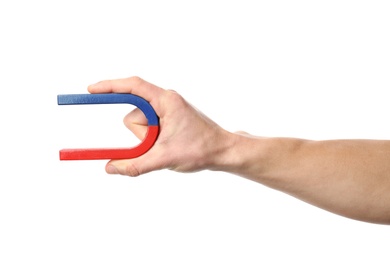 Photo of Man holding magnet on white background, closeup