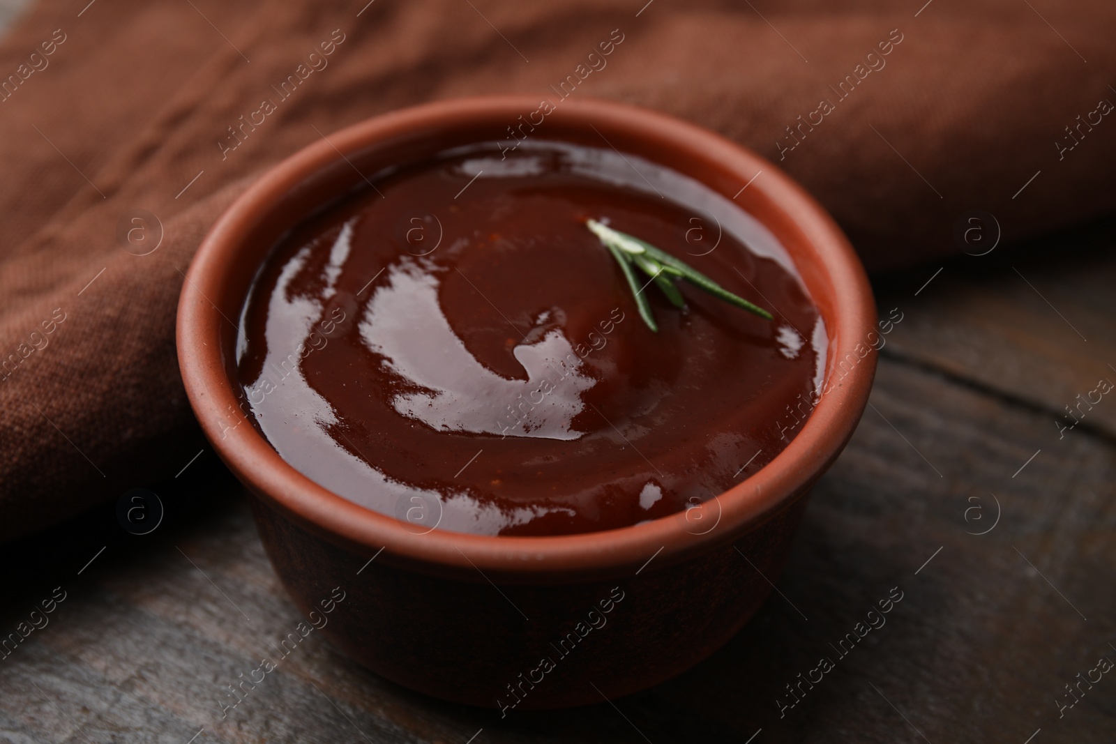 Photo of Marinade in bowl on wooden table, closeup