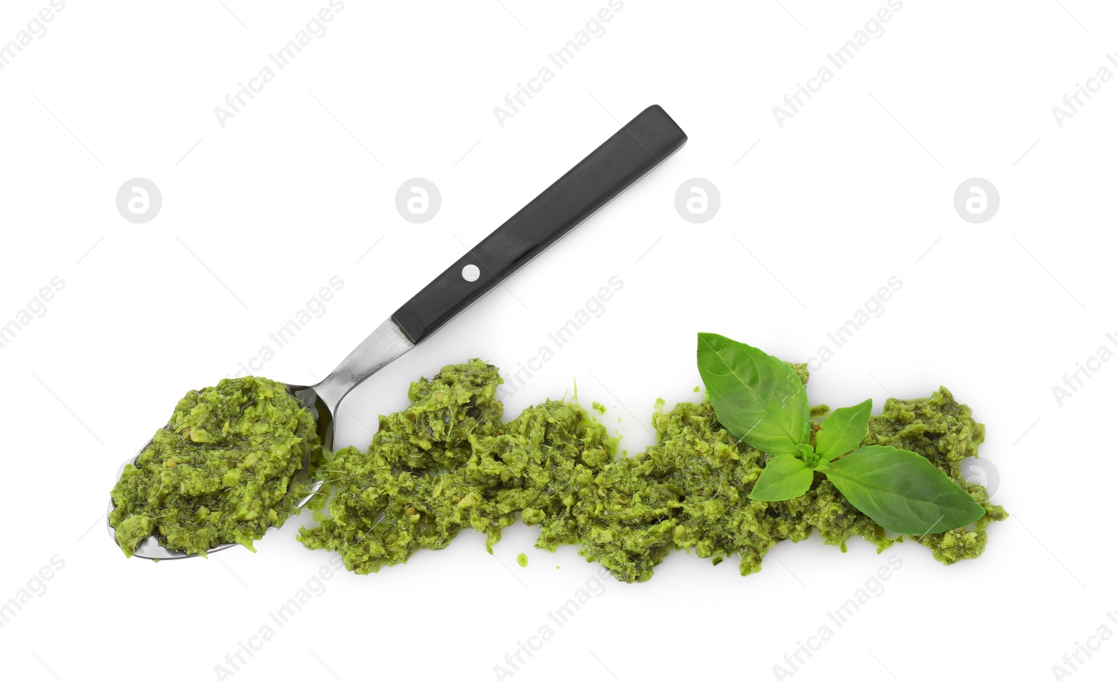 Photo of Spoon with delicious pesto sauce and basil leaves isolated on white, top view