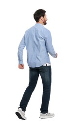 Handsome man in stylish outfit walking on white background, back view