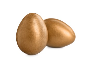 Photo of Two golden eggs on white background. Pension concept